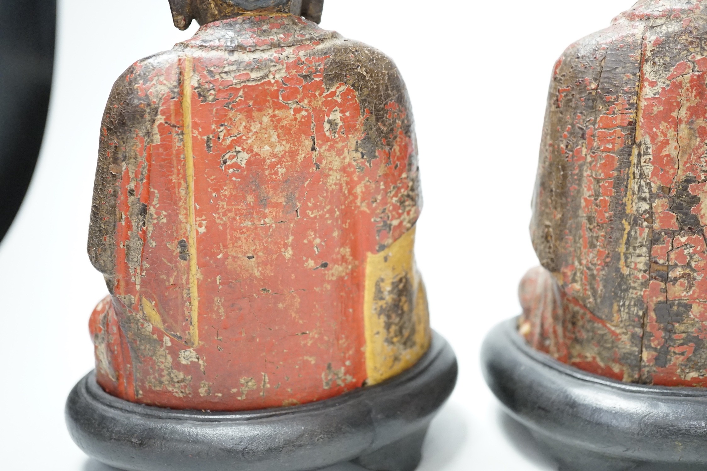 A set of three Chinese polychrome lacquered wood seated figures of Buddha, 19cm